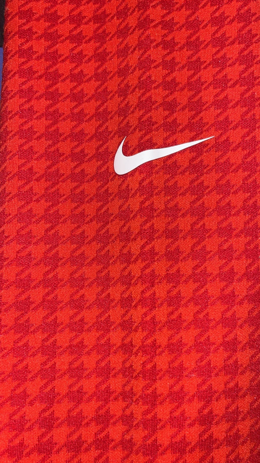 Nike Swoosh detail on red orange houndstooth leggings ankle