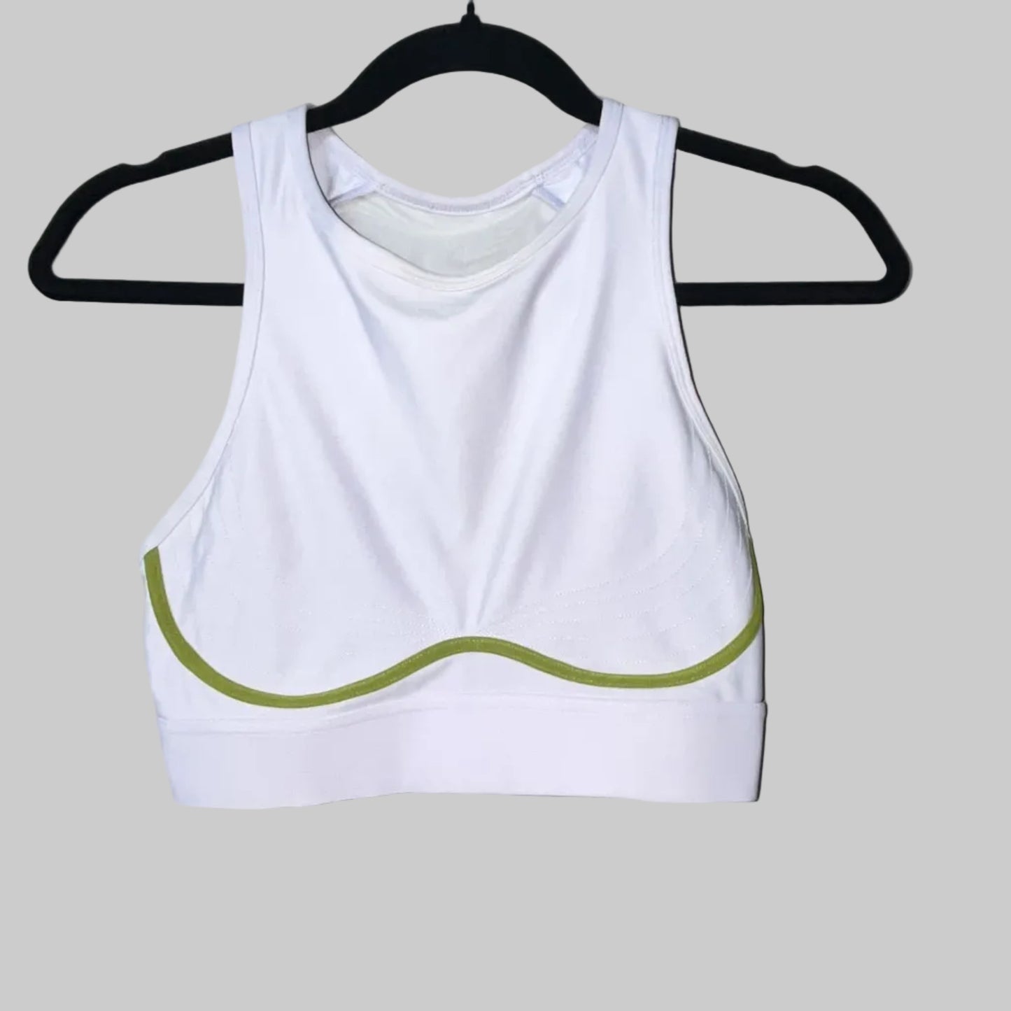 Fabletics white and olive sports bra front view with green trim detail, size Medium