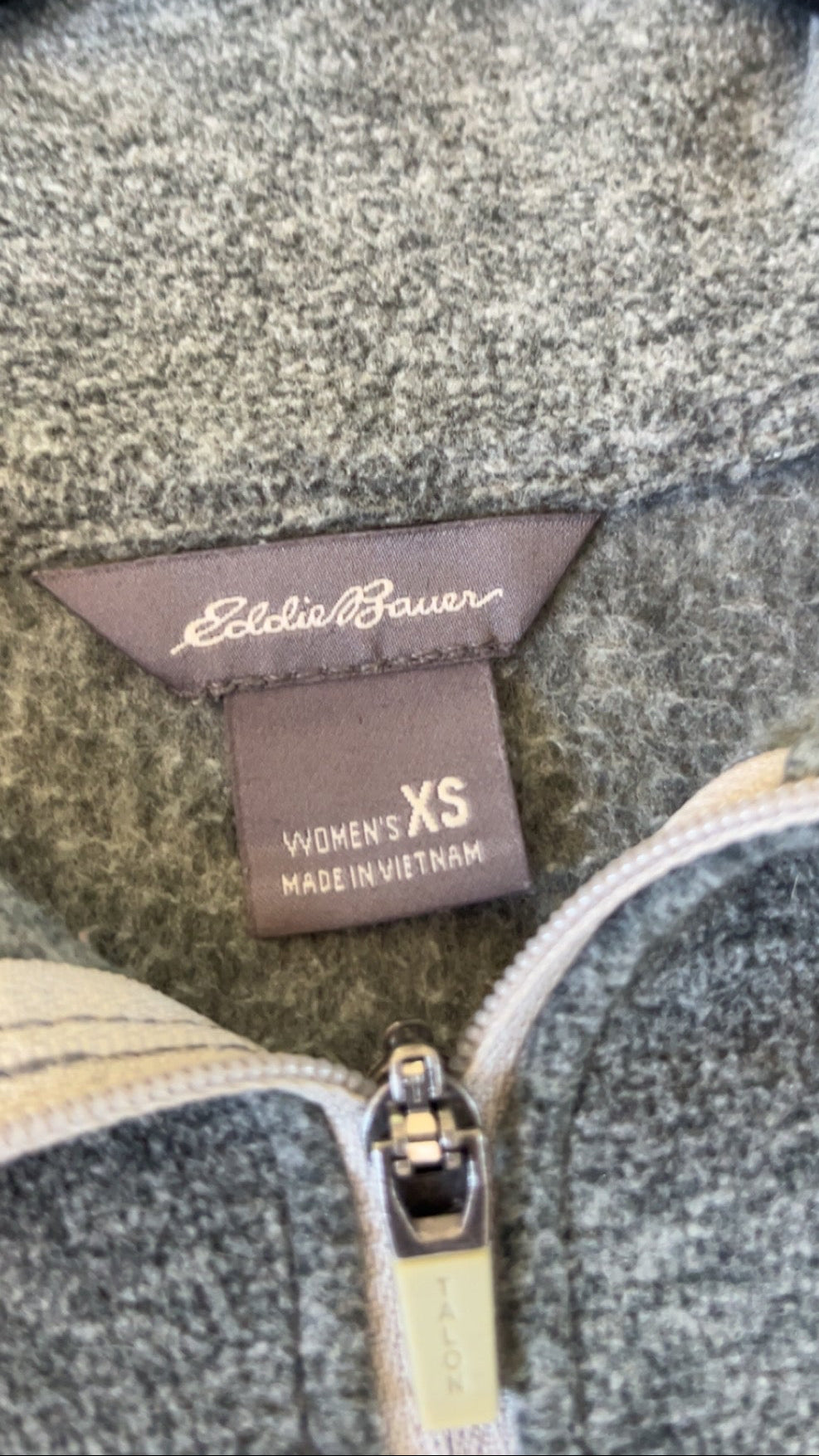 Eddie Bauer label showing women's XS on grey fleece pullover